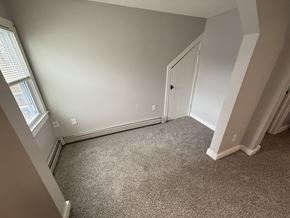 Concord apartment for rent - A room with a carpeted floor and a white door.