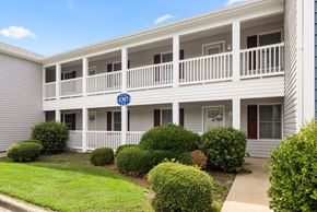 Greenville apartment for rent - A building with a balcony and a sign that says 1107.