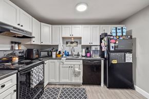 Concord apartment for rent - A kitchen with black and white appliances and cabinets.