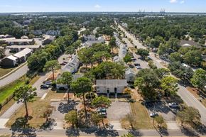 Wilmington apartment for rent - A bird's eye view of a residential area with houses, trees, and parked cars.