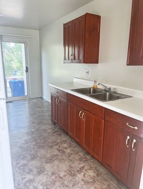 Inkster apartment for rent - A kitchen with wooden cabinets and a double sink