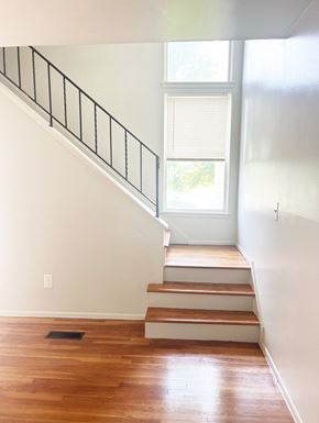 Inkster apartment for rent - A photo of a bright staircase with a window and a black railing.
