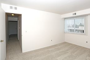 Clinton Twp apartment for rent - an empty living room with a large window and white walls