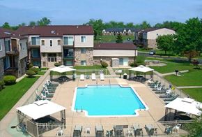 Clinton Twp apartment for rent - an aerial view of an outdoor pool with chairs and umbrellas
