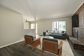 Topeka apartment for rent - A living room with a couch, chairs, and a fireplace.