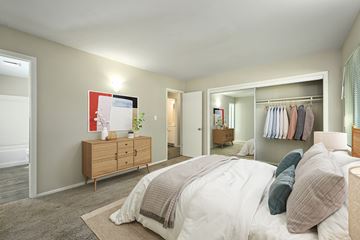 Topeka apartment for rent - A bedroom with a large bed and a wooden dresser.