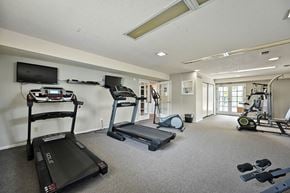 Topeka apartment for rent - A spacious gym with treadmills, elliptical machines, and other exercise equipment.