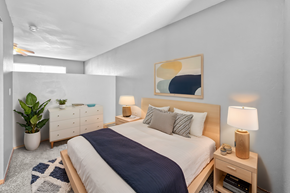 Lawrence apartment for rent - A bedroom with a large bed and a painting on the wall.