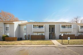 Topeka apartment for rent - Apartment building with a brown fence in front.