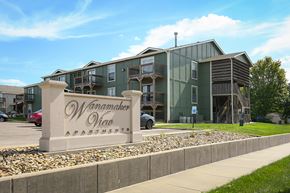 Topeka apartment for rent - A large building with the name Wanamaker View Apartments on a stone pillar in front.