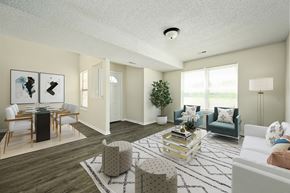 Lawrence townhouse for rent - an open living room and dining room with white walls and a large window