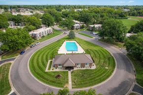 Topeka apartment for rent - A bird's eye view of an apartment complex's communal space with a swimming pool and other amenities.