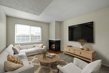 Topeka apartment for rent - A living room with a fireplace and a television mounted on the wall.