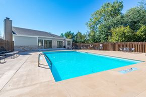 Topeka apartment for rent - a swimming pool with a house in the background