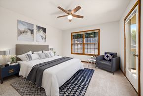 Topeka apartment for rent - a bedroom with a large bed and a ceiling fan