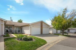 Topeka apartment for rent - A residential area with houses and a tree.