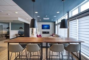 Winnipeg townhouse for rent - A modern dining room with a wooden table and grey chairs.