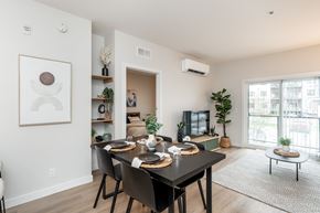 Winnipeg apartment for rent - A modern dining room with a black table and chairs.