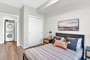 Calgary apartment for rent - A bedroom with a bed, nightstand, and a painting on the wall.