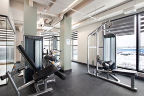 Calgary apartment for rent - A gym with a row of exercise machines.