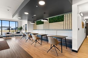 Regina townhouse for rent - A modern dining area with wooden floors and white walls.
