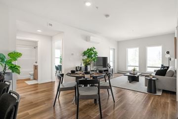 Calgary apartment for rent - A modern living room with a dining table and chairs.