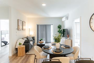 Calgary apartment for rent - A modern living room with a dining table set for four.
