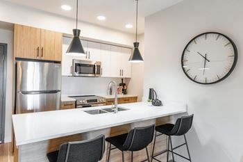 A kitchen with a clock on the wall