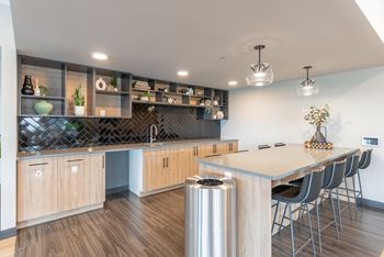 A modern kitchen with wooden cabinets and a large island.