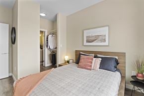 Regina townhouse for rent - A bedroom with a large bed and a painting on the wall.