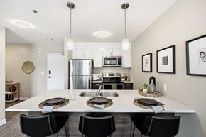 Winnipeg apartment for rent - A modern kitchen with a dining table set for four.