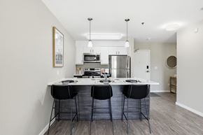 Winnipeg apartment for rent - A kitchen with a table and chairs in the middle of the room.