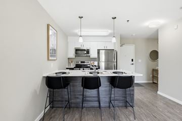 Winnipeg apartment for rent - A kitchen with a table and chairs in the middle of the room.