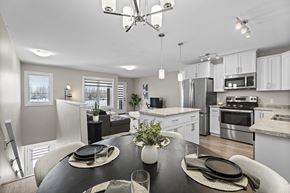 Regina apartment for rent - A modern kitchen with a dining table set for two.
