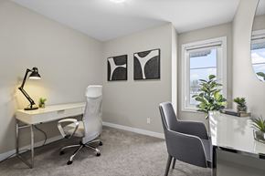 Regina apartment for rent - A room with a desk, chair, and two framed pictures on the wall.