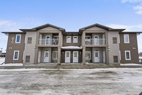 Regina apartment for rent - A row of three houses with brown and beige exteriors.
