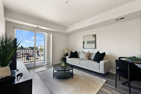 Regina apartment for rent - A living room with a couch, coffee table, and sliding glass doors.