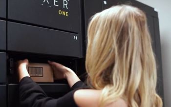 A woman is opening a black filing cabinet