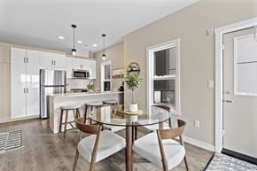 Regina townhouse for rent - A modern kitchen with a dining table and chairs.