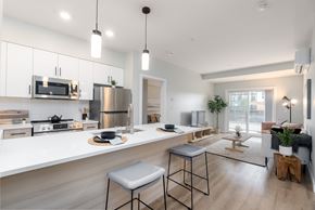 Sherwood Park apartment for rent - A modern kitchen with a stainless steel refrigerator and a white countertop.