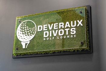 A sign for deveraux divots golf lounge