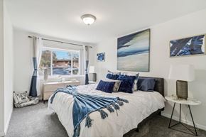 Oxon Hill apartment for rent - a bedroom with a bed and a large window at Oaks at Oxon Hill, Oxon Hill, Maryland