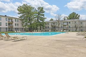 Suitland apartment for rent - our apartments have a resort style pool with lounge chairs at Andrews Ridge Apartments, Suitland, MD