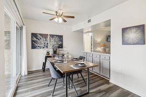 Oxon Hill apartment for rent - a dining room with a table and a ceiling fan at Oaks at Oxon Hill, Oxon Hill, Maryland