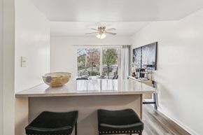 Oxon Hill apartment for rent - a kitchen with a counter top and a large window at Oaks at Oxon Hill, Oxon Hill, Maryland