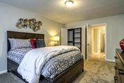 Hoover apartment for rent - A bedroom with a large bed and a wall decoration at The Onyx Hoover Apartments, Hoover