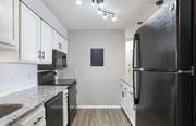 Hoover apartment for rent - A black refrigerator is on the right side of a kitchen at The Onyx Hoover Apartments, Hoover, AL