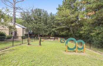 A playground with a green and yellow swing set.