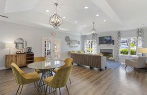Hoover apartment for rent - A modern dining room with a glass table and yellow chairs at The Onyx Hoover Apartments, Alabama