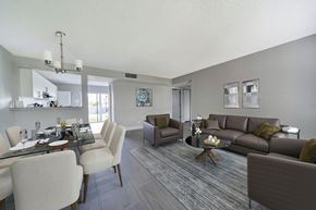 West Palm Beach townhouse for rent - A modern living room with a dining table and chairs.